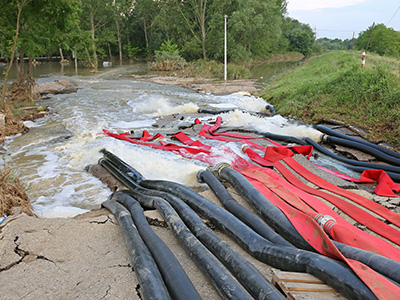 Pipes and hoses pumping out flood water